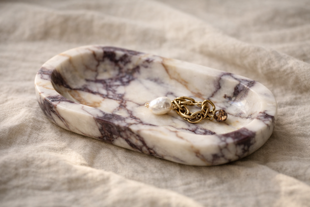 photo_3_handcrafted_suzy_decor_jewelry_resting_in_calacatta_viola_marble_tray_soft_purple_and_beige_veining_quiet_luxury_editorial_still_life