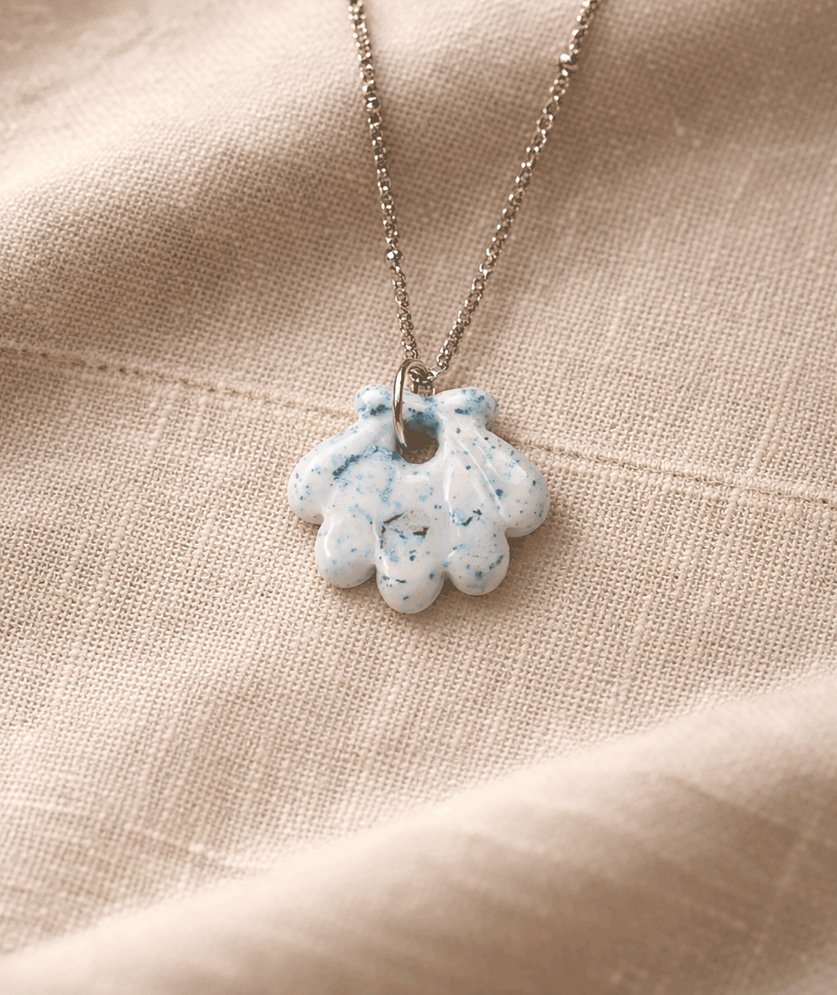 handmade_ceramic_shell_pendant_white_blue_speckled_glossy_camino_inspired_necklace