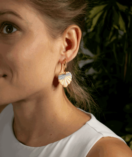 Close-up of a woman wearing Pastel Shell Earrings with sculpted polymer clay charms and gold-tone hoops