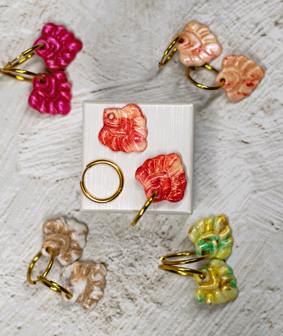 charm_14_c2 coral red hoop earrings displayed with handmade polymer clay earrings in fuchsia, peach, mint green and beige