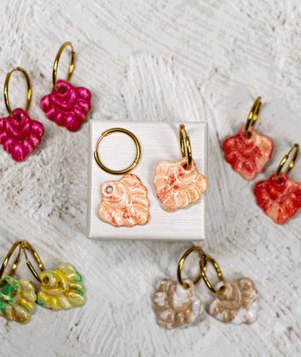 ivory coral hoop earrings displayed with handmade coral-shaped earrings in fuchsia, coral red, mint green and beige