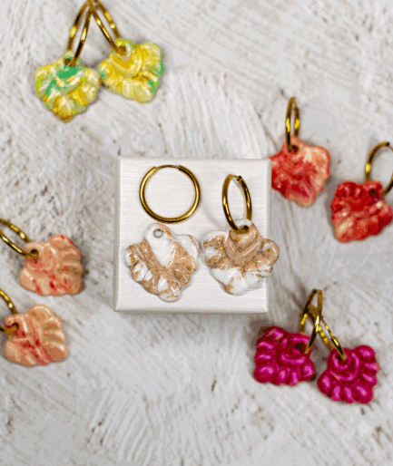 beige coral hoop earrings displayed with handmade polymer clay earrings in mint green, coral red, peach and fuchsia pink