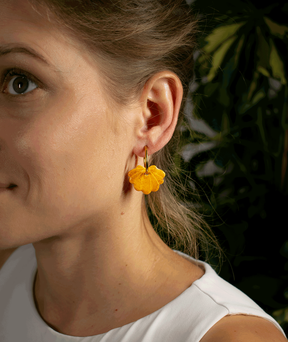 charm_21_b woman wearing yellow shell hoop earrings with golden yellow seashell charms and gold-tone hoops